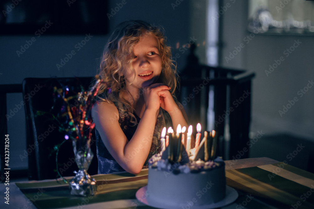 Happy child blowing out birthday candles