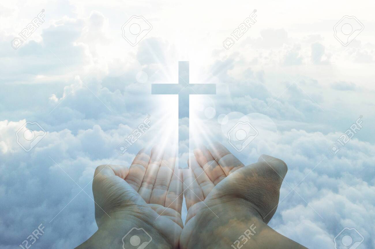 Hands reaching out towards a shining cross