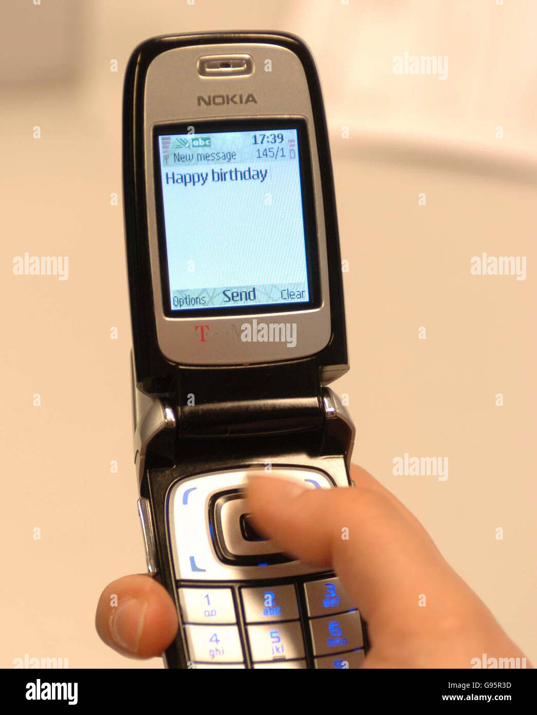 Image: Person holding a smartphone sending a birthday message
