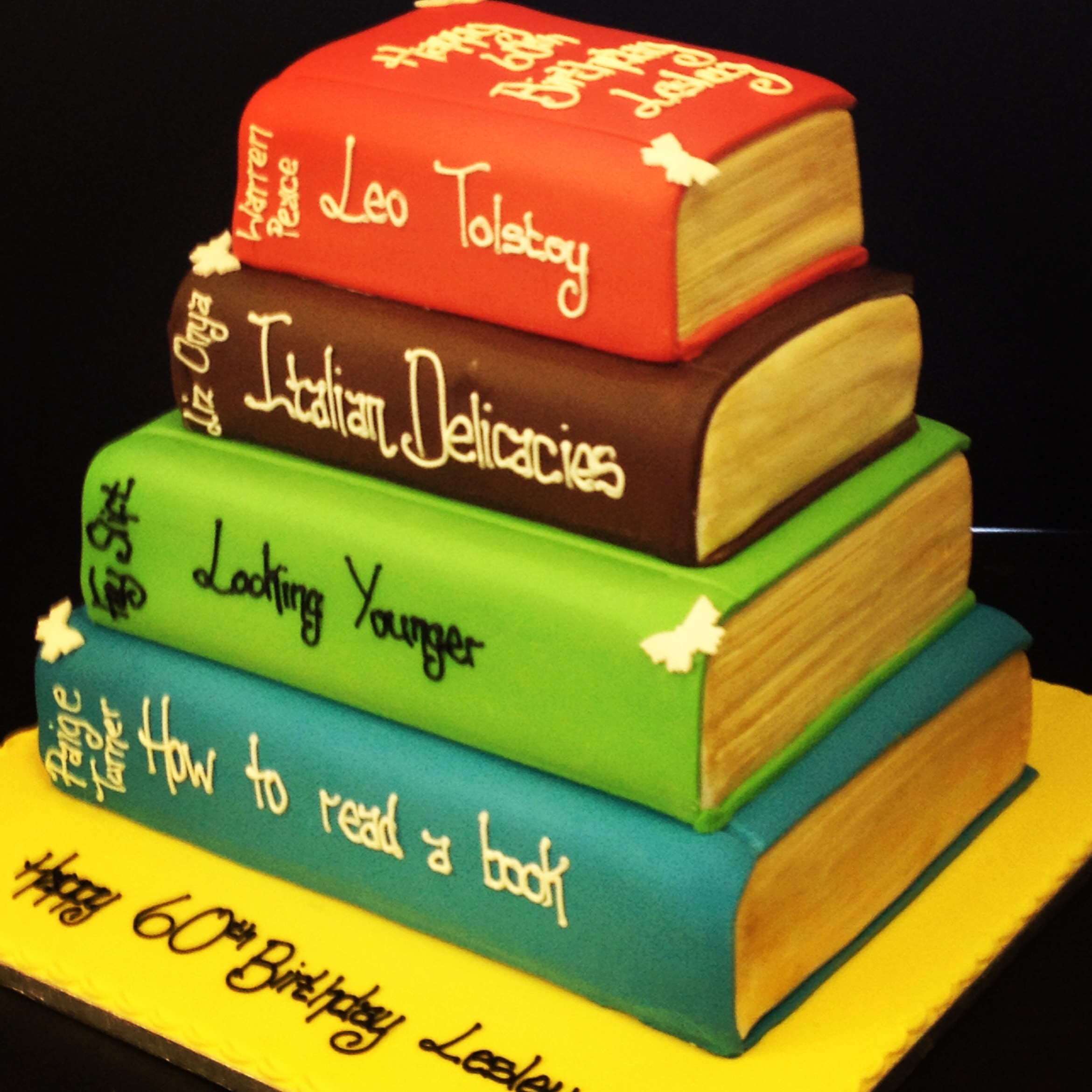 Stack of books with a birthday cake