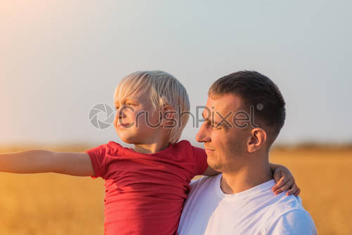 stock photo young father holds son on hands and looks into distance paternal care and responsibility 3080518