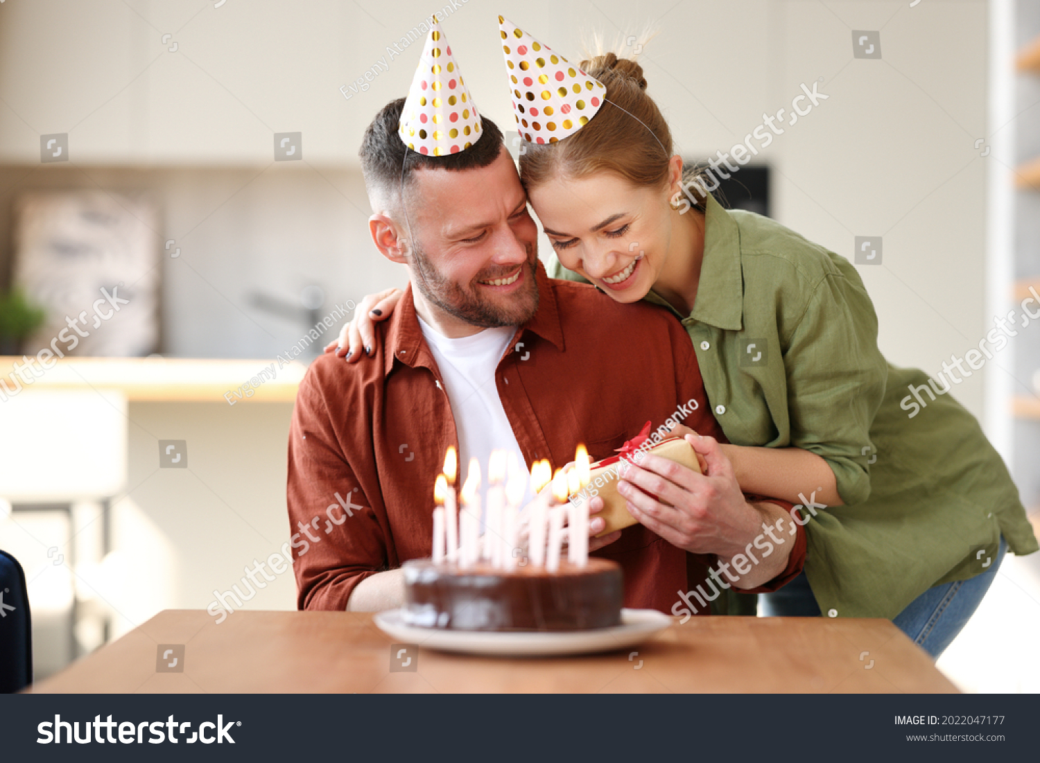 Happy couple celebrating birthday with romantic surprise